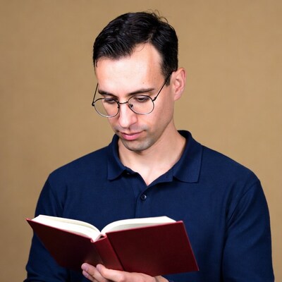 Man reading book in glasses