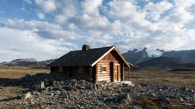 Log cabin amid rocky mountains