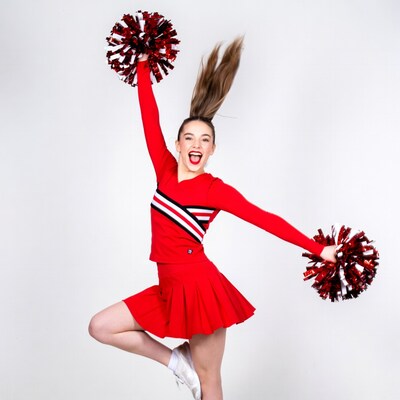 Cheerleader girl jumping with pom poms