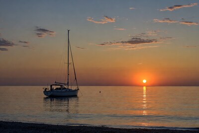Sailboat anchored at sunset