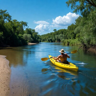 Man kayaking in yellow kayak on river