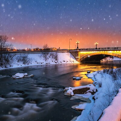 Snowy Bridge Over River at Dusk
