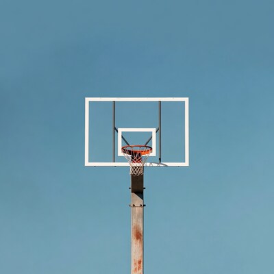Rusty Basketball Hoop Against Blue Sky