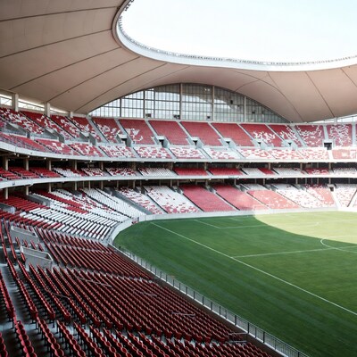 Empty modern soccer stadium with red seats