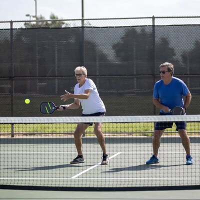 Two men playing pickleball on court