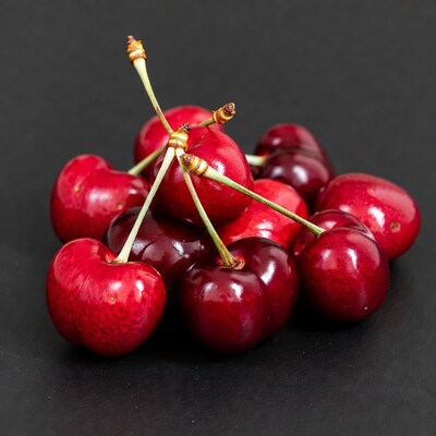 Fresh red cherries on black background