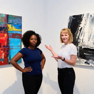 Two women posing in art gallery