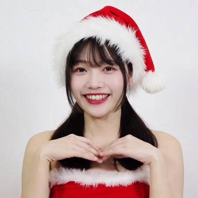 Asian woman in Santa hat heart gesture