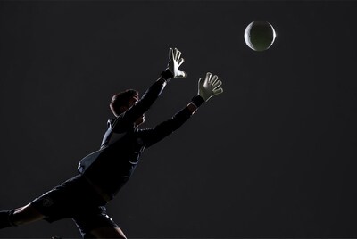 Soccer goalkeeper jumping for ball