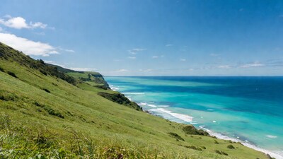 Green Cliffs Over Turquoise Ocean