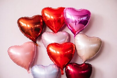 Colorful Heart Balloons on Pink Background