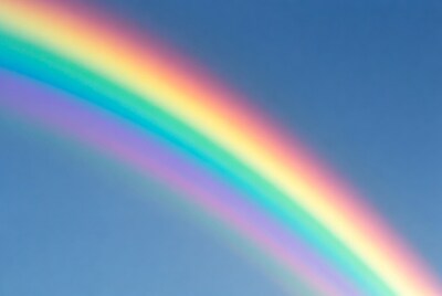 Vibrant rainbow in blue sky