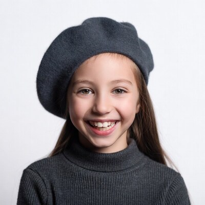Girl smiling in gray beret