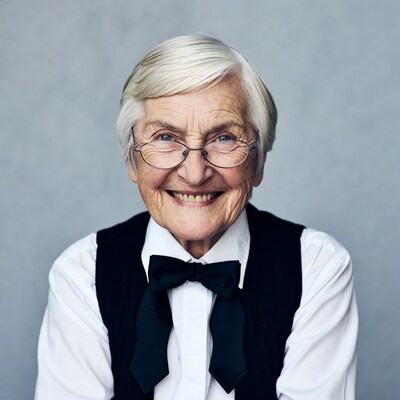 Elderly woman smiling with bow tie