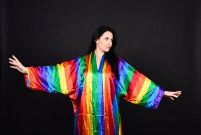 Woman in rainbow kimono on black background