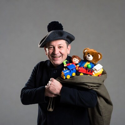 Smiling man holding toy-filled sack