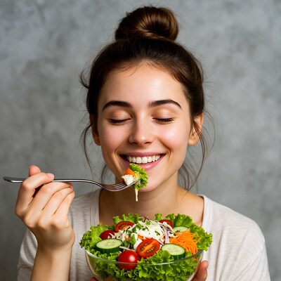 Woman eating fresh salad