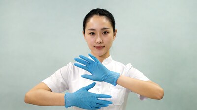 Asian nurse showing blue gloves