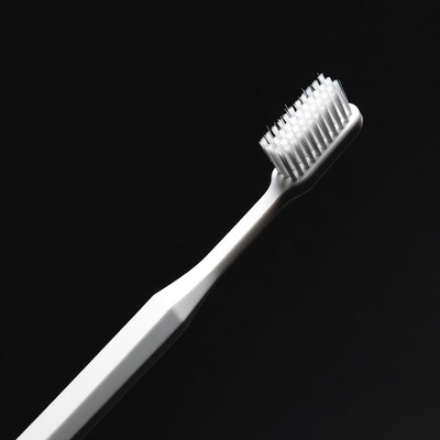 White Toothbrush on Black Background