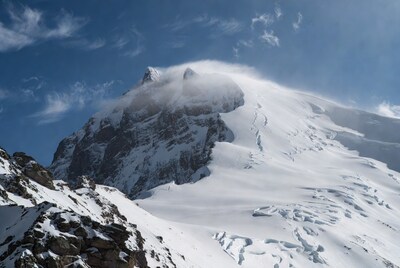 Snowy Mountain Peak with Clouds