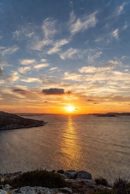 Sunset over rocky coastline and sea