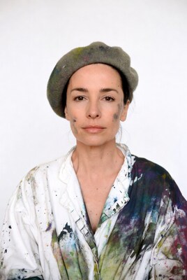 Woman in paint-splattered smock and beret