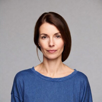 Woman with brown hair in blue top