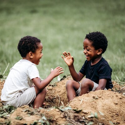 Two African-American boys playing in dirt