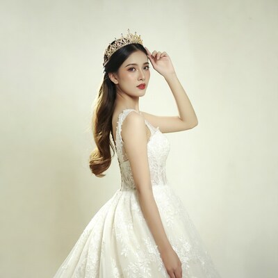 Asian bride in white lace gown with tiara