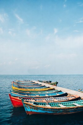 Colorful boats docked on wooden pier