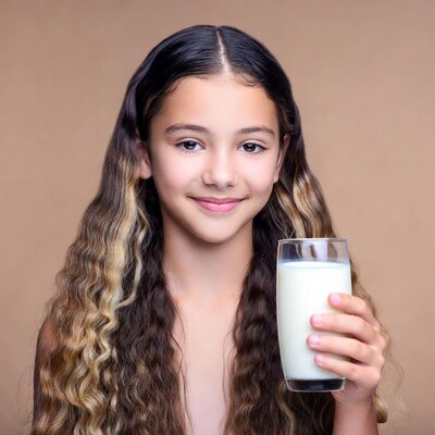 Girl holding glass of milk