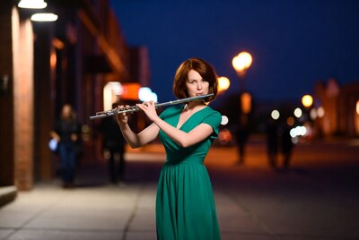 Woman playing flute at night street