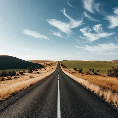 Endless road through golden hills