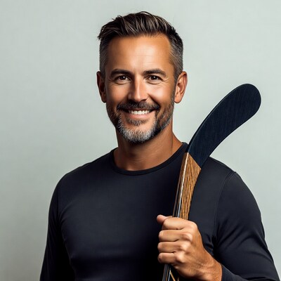 Smiling man holding hockey stick