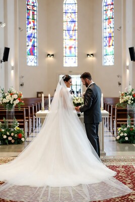 Bride and groom exchanging rings at altar