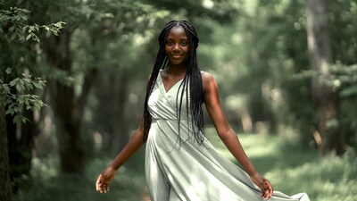 African woman in green dress in forest