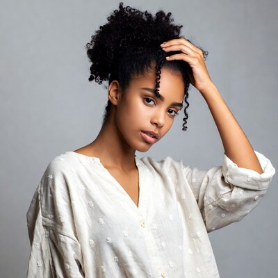 African-American woman touching curly hair