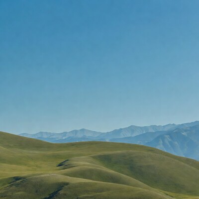 Green Rolling Hills and Distant Mountains