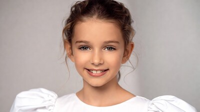 Smiling girl in white puffy sleeve dress