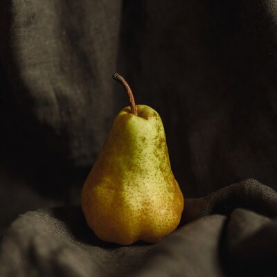 Ripe Pear on Dark Fabric