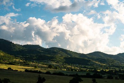 Green Mountains with Fluffy Clouds