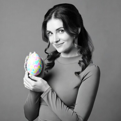 Woman holding colorful Easter egg