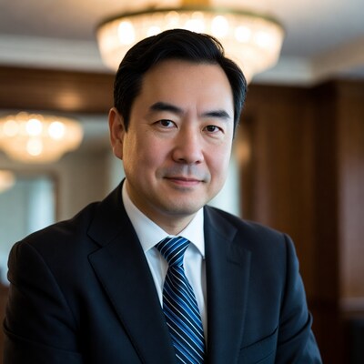 Asian man in suit with chandelier background