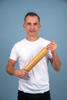 Man holding wooden rolling pin