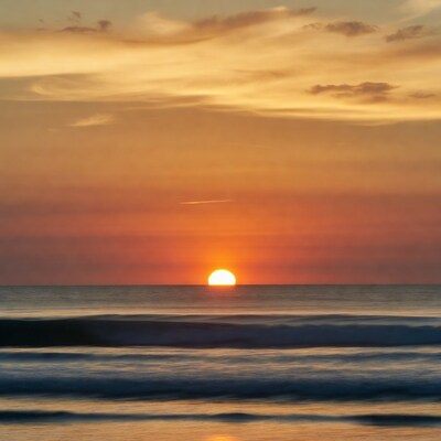 Sunset over ocean waves