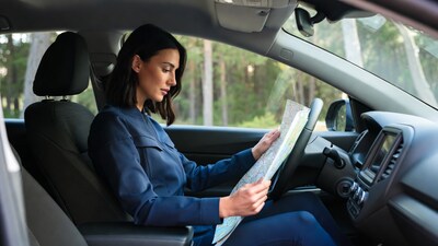 Woman reading map in car