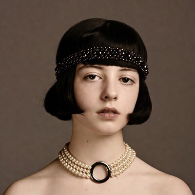 Woman with bob haircut and pearl necklace