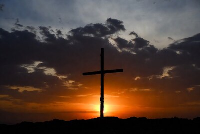 Silhouette cross at sunset