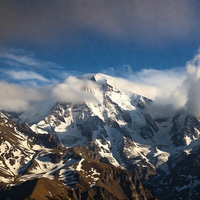 Snowy Mountain Peak with Clouds