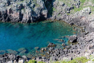 Turquoise cove surrounded by volcanic rocks